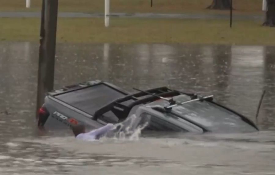 Brave Reporter Leaps Into Floodwaters to Rescue Trapped Driver